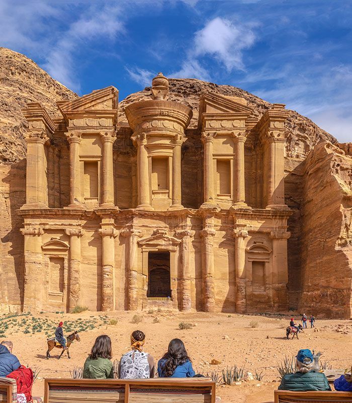PETRA, JORDAN - January 13  2020: Nabatean ancient city of Petra. Facade of the Ad Deir The Monastery with tourists Temple In Petra In Jordan